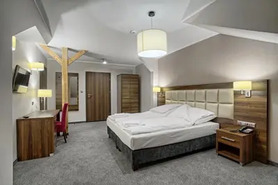 Łóżko lub łóżka w pokoju w obiekcie Hotel Kamieniczka