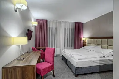 Łóżko lub łóżka w pokoju w obiekcie Hotel Kamieniczka