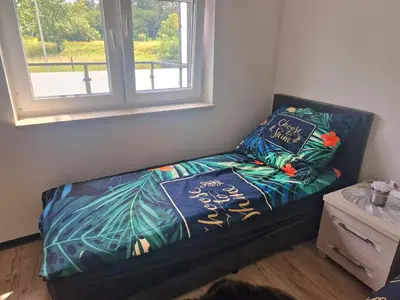 Łóżko lub łóżka w pokoju w obiekcie Apartament Słoneczny Taras nad Baryczą