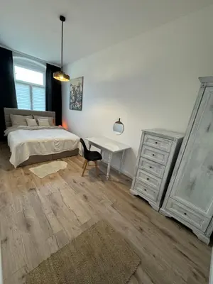 Łóżko lub łóżka w pokoju w obiekcie Apartament Chopina