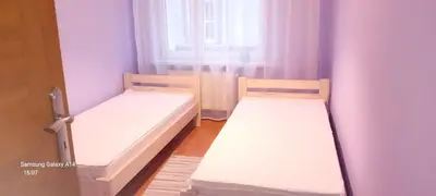 Łóżko lub łóżka w pokoju w obiekcie Apartament pod Twierdzą