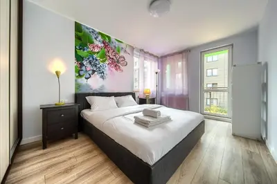 Łóżko lub łóżka w pokoju w obiekcie Babiego Lata Spacious Apartment