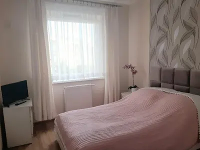 Łóżko lub łóżka w pokoju w obiekcie Apartament Magellana
