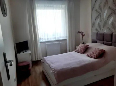 Łóżko lub łóżka w pokoju w obiekcie Apartament Magellana