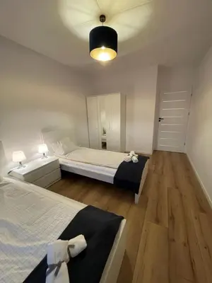 Łóżko lub łóżka w pokoju w obiekcie Apartament Park Poezji II