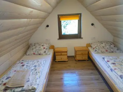 Łóżko lub łóżka w pokoju w obiekcie Domek Nad Strumykiem