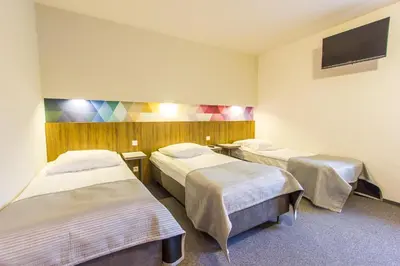 Łóżko lub łóżka w pokoju w obiekcie Hotel Platan