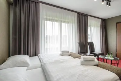 Łóżko lub łóżka w pokoju w obiekcie Hotel Olimp