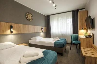 Łóżko lub łóżka w pokoju w obiekcie Hotel Olimp