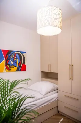 Łóżko lub łóżka w pokoju w obiekcie Apartament Mikołowska z balkonem