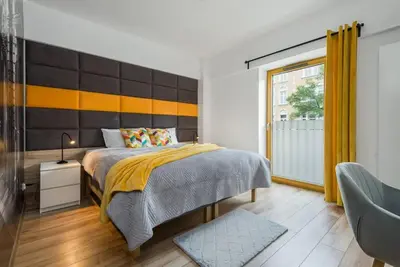 Łóżko lub łóżka w pokoju w obiekcie Zygmunta Starego 2-Bedroom Condo