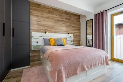 Łóżko lub łóżka w pokoju w obiekcie Zygmunta Starego 2-Bedroom Condo