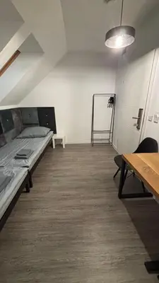 Łóżko lub łóżka w pokoju w obiekcie Pokoje Pod Pałacem