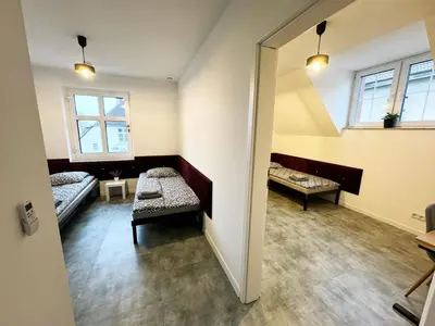 Łóżko lub łóżka w pokoju w obiekcie Pokoje Pod Pałacem