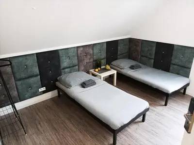 Łóżko lub łóżka w pokoju w obiekcie Pokoje Pod Pałacem