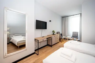 Łóżko lub łóżka w pokoju w obiekcie Apartamenty Castello