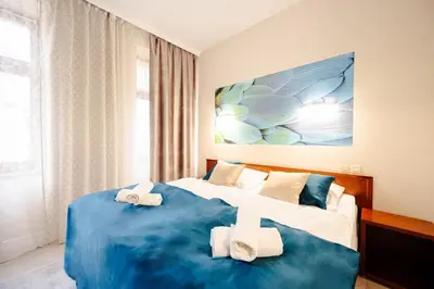 Łóżko lub łóżka w pokoju w obiekcie Apartamenty Castello