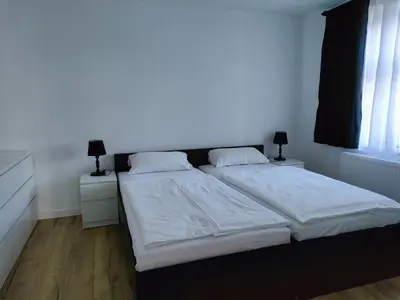 Łóżko lub łóżka w pokoju w obiekcie Apartamenty Dom Zielony