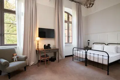 Łóżko lub łóżka w pokoju w obiekcie ARCHE Klasztor Wrocław