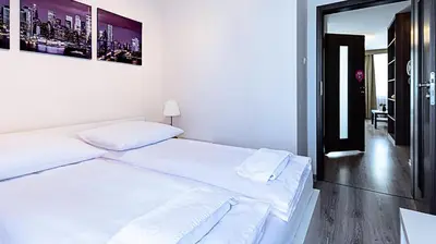 Łóżko lub łóżka w pokoju w obiekcie Vacation Club - Aleja Zwycięzców 6F Apartament 15