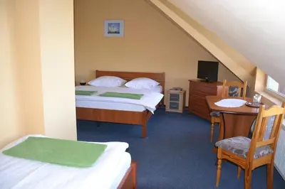 Łóżko lub łóżka w pokoju w obiekcie Hotelik Orlik