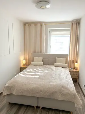Łóżko lub łóżka w pokoju w obiekcie Biszkoptowy Apartament