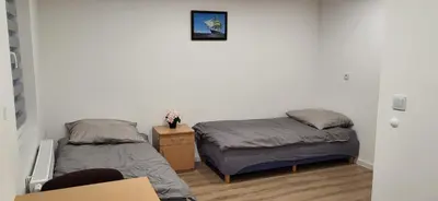 Łóżko lub łóżka w pokoju w obiekcie Apartamenty Ścinawa