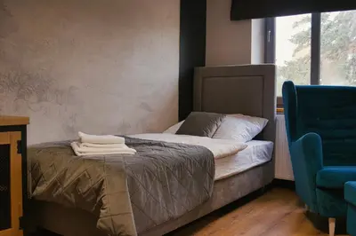 Łóżko lub łóżka w pokoju w obiekcie Gościniec Stara Mleczarnia