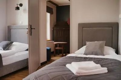 Łóżko lub łóżka w pokoju w obiekcie Gościniec Stara Mleczarnia