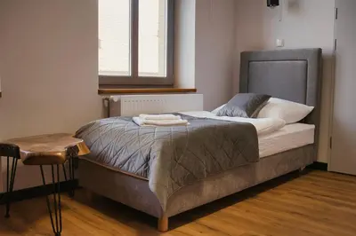 Łóżko lub łóżka w pokoju w obiekcie Gościniec Stara Mleczarnia
