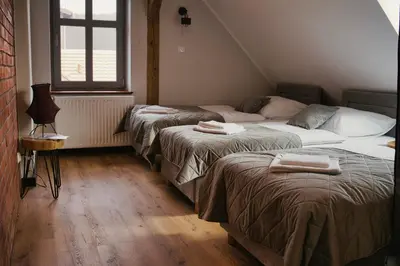 Łóżko lub łóżka w pokoju w obiekcie Gościniec Stara Mleczarnia