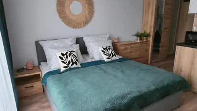 Łóżko lub łóżka w pokoju w obiekcie Apartament Gamma Zwycięska Wrocław