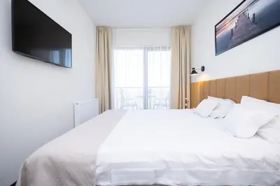 Łóżko lub łóżka w pokoju w obiekcie Hotel ARDEN
