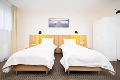 Łóżko lub łóżka w pokoju w obiekcie Hotel ARDEN