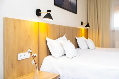 Łóżko lub łóżka w pokoju w obiekcie Hotel ARDEN