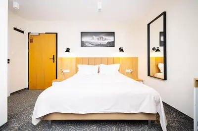 Łóżko lub łóżka w pokoju w obiekcie Hotel ARDEN