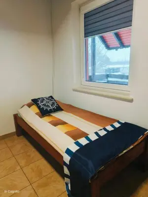 Łóżko lub łóżka w pokoju w obiekcie Domek w Miasteczku Portowym nr 3