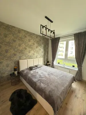 Łóżko lub łóżka w pokoju w obiekcie Stylowy apartament z ogródkiem i tarasem