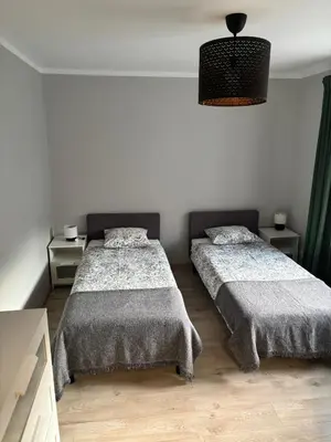 Łóżko lub łóżka w pokoju w obiekcie Agroturystyka pod lasem