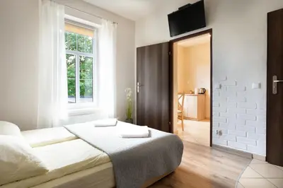 Łóżko lub łóżka w pokoju w obiekcie 4 Apartamenty W Centrum