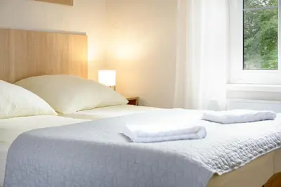 Łóżko lub łóżka w pokoju w obiekcie 4 Apartamenty W Centrum