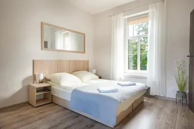Łóżko lub łóżka w pokoju w obiekcie 4 Apartamenty W Centrum