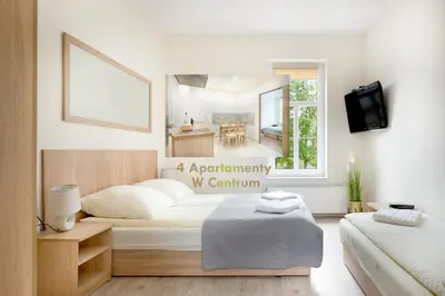 Łóżko lub łóżka w pokoju w obiekcie 4 Apartamenty W Centrum