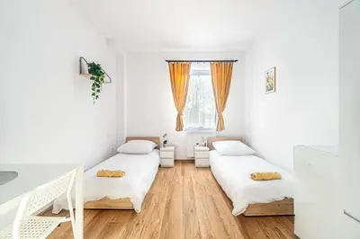 Łóżko lub łóżka w pokoju w obiekcie Hostel PW INVEST HOME