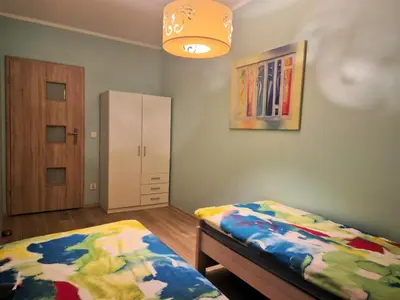 Łóżko lub łóżka w pokoju w obiekcie Apartament DĄBROWSKIEGO