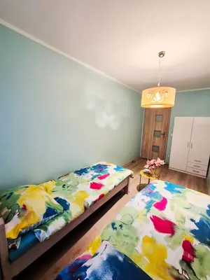 Łóżko lub łóżka w pokoju w obiekcie Apartament DĄBROWSKIEGO