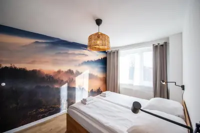 Łóżko lub łóżka w pokoju w obiekcie Apartament Korfantego 9