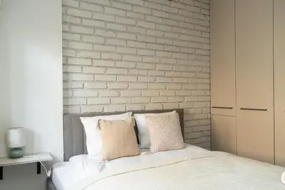 Łóżko lub łóżka w pokoju w obiekcie RentPlanet - Apartament Szczytnicka