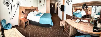 Łóżko lub łóżka w pokoju w obiekcie Hotel Milenium