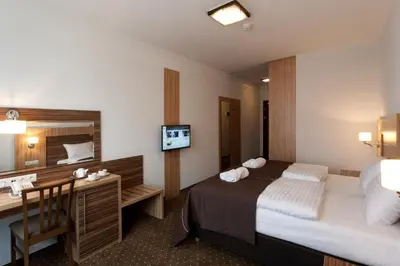 Łóżko lub łóżka w pokoju w obiekcie Hotel Milenium